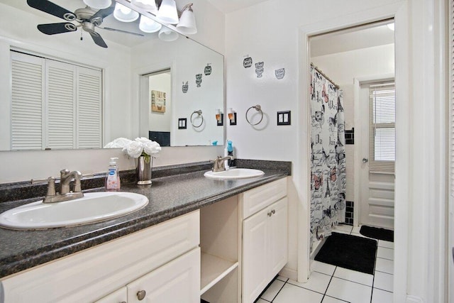 bathroom featuring curtained shower, ceiling fan, tile patterned flooring, and vanity