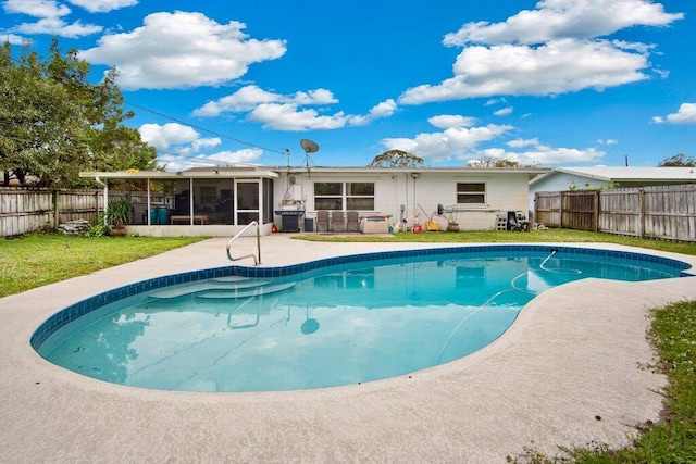 view of swimming pool featuring a patio area and a sunroom