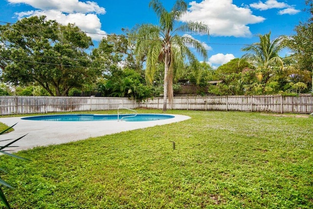 view of pool with a yard