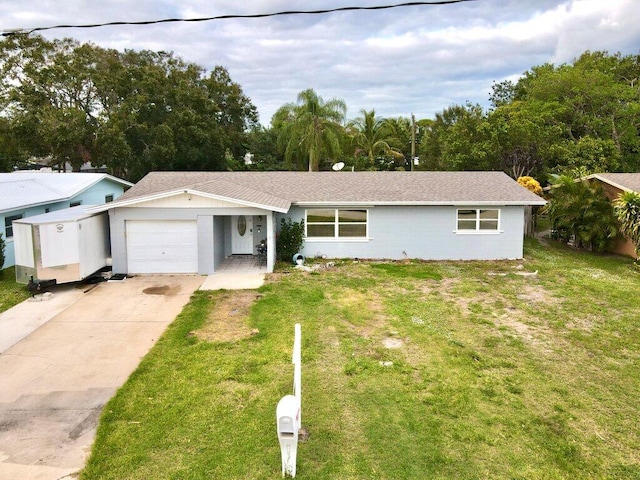 single story home with a garage and a front lawn