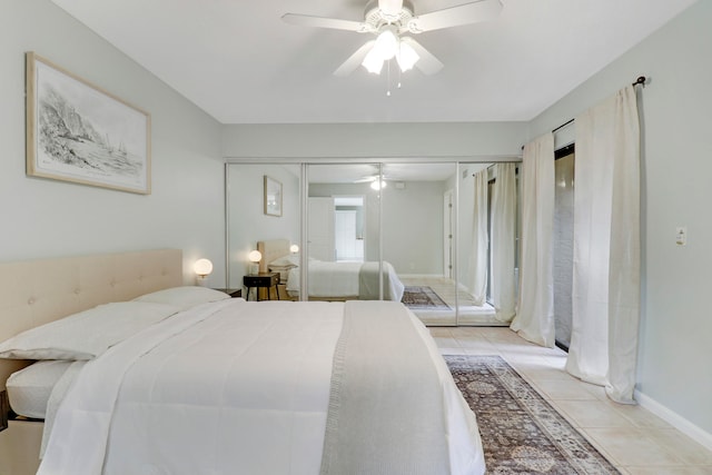 bedroom with a closet, ceiling fan, and light tile patterned flooring