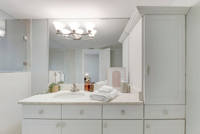 bathroom with vanity and an inviting chandelier