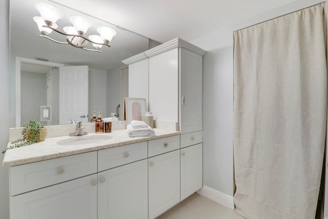 bathroom with vanity and an inviting chandelier