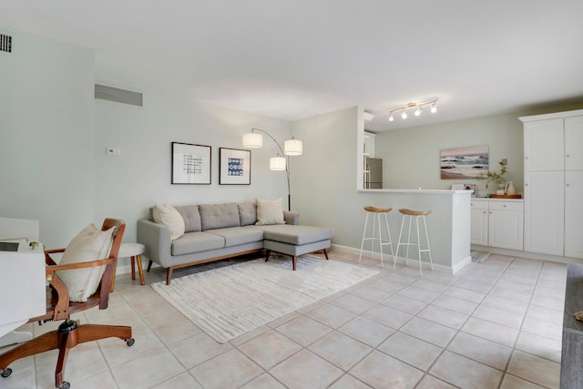 tiled living room featuring bar area