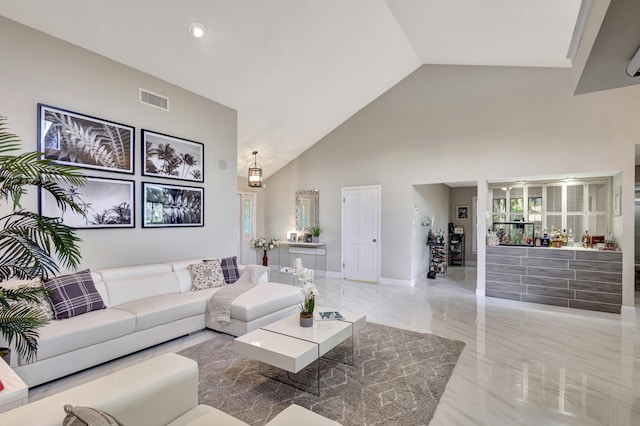 dining room featuring ceiling fan with notable chandelier, a textured ceiling, and high vaulted ceiling