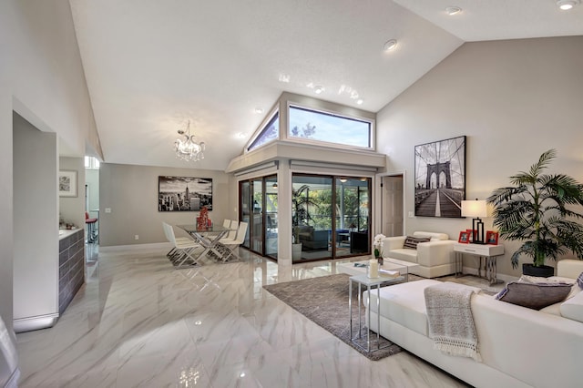 living room with high vaulted ceiling and a notable chandelier