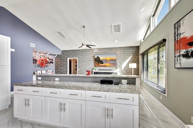 kitchen with double oven, black electric cooktop, white cabinetry, and sink