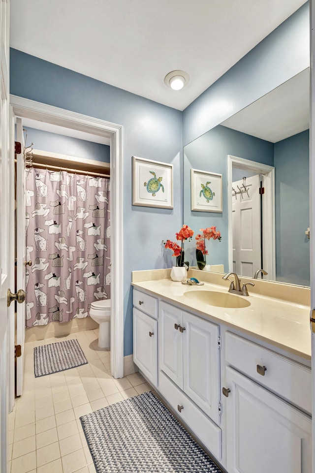 bathroom featuring tile patterned floors, vanity, and toilet