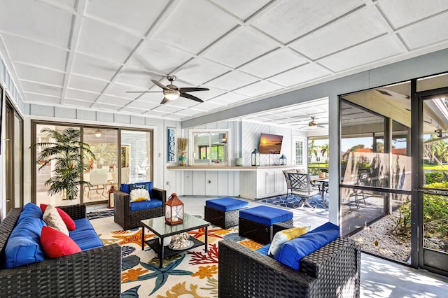 sunroom / solarium featuring ceiling fan and plenty of natural light