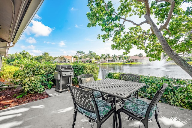 view of patio / terrace featuring a water view and grilling area