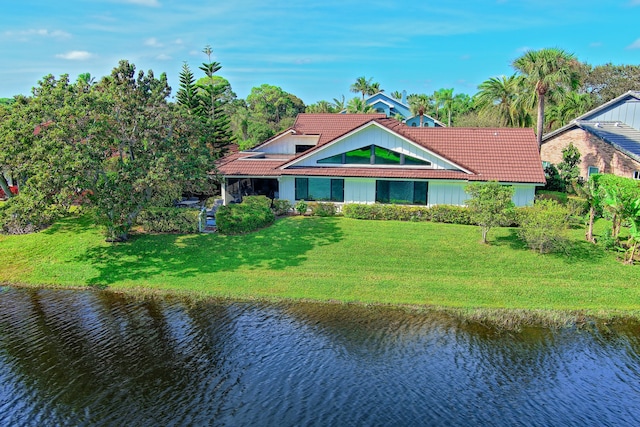 view of front of house with a front yard and a water view