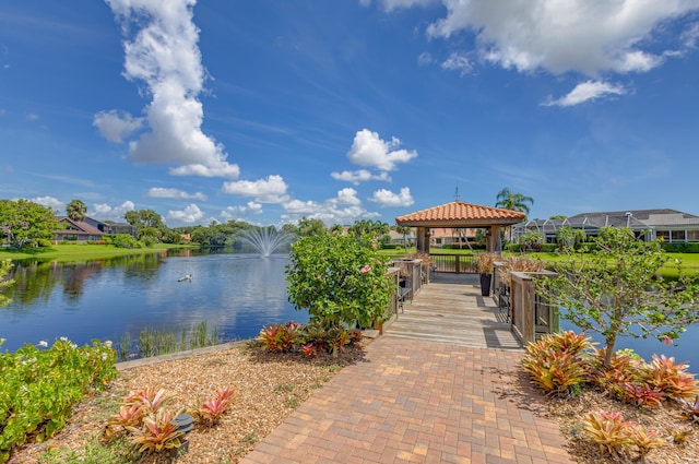 view of dock featuring a gazebo and a water view