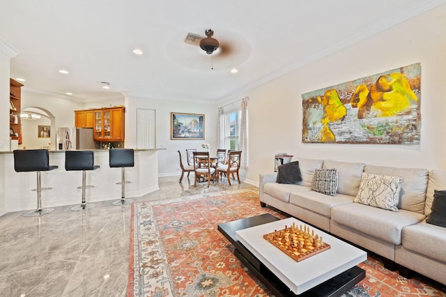 living room featuring crown molding and ceiling fan