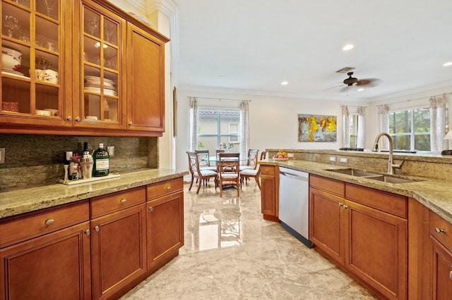 kitchen with stainless steel dishwasher, sink, crown molding, and a wealth of natural light