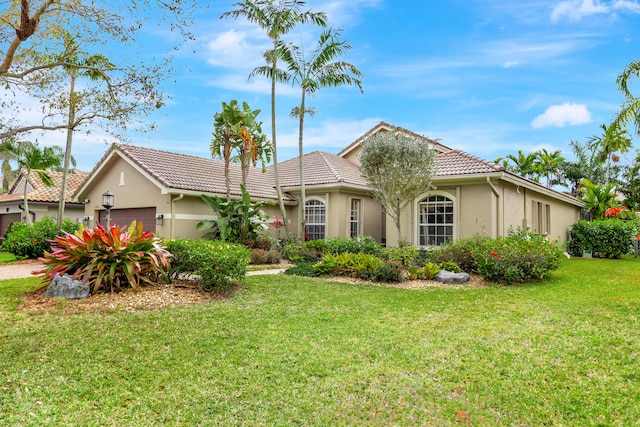 view of front of home featuring a front yard and a garage