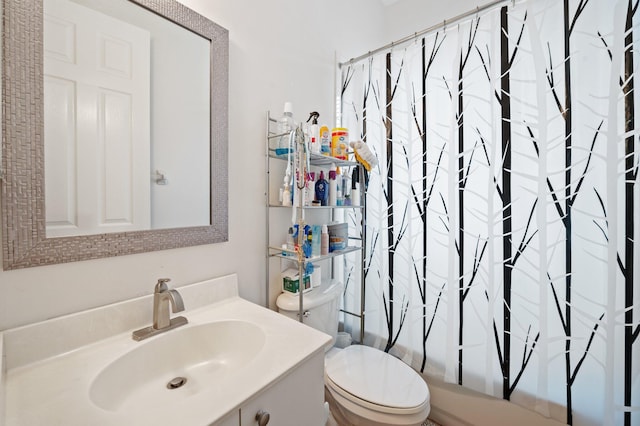 full bathroom with vanity, shower / tub combo, and toilet