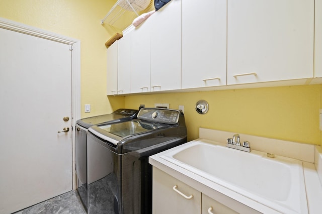 clothes washing area with cabinets, independent washer and dryer, and sink