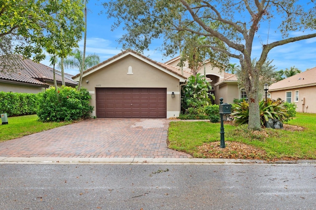 view of front of house featuring a garage and a front yard