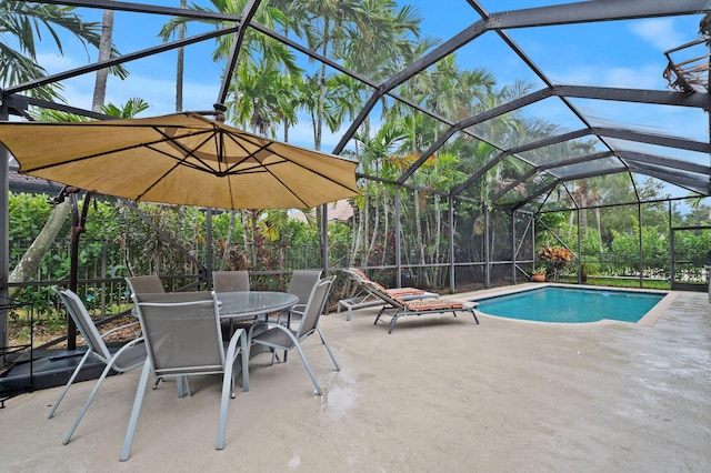 view of swimming pool with a patio area and a lanai