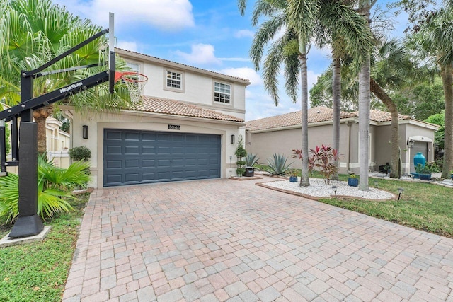 mediterranean / spanish-style home with a garage