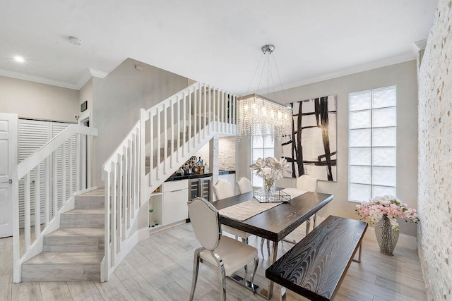 dining space with light wood-type flooring and crown molding