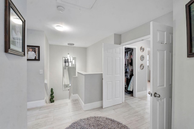 hallway with light hardwood / wood-style flooring