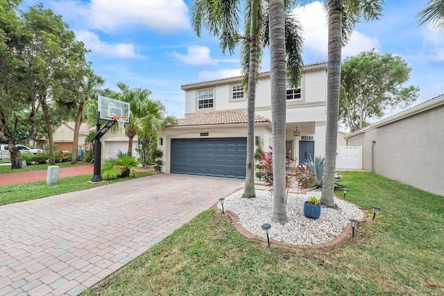 mediterranean / spanish house with a garage and a front lawn