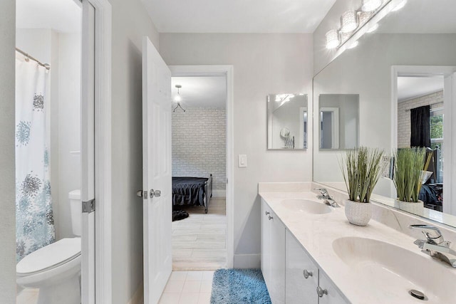 bathroom featuring a fireplace, tile patterned flooring, vanity, and toilet