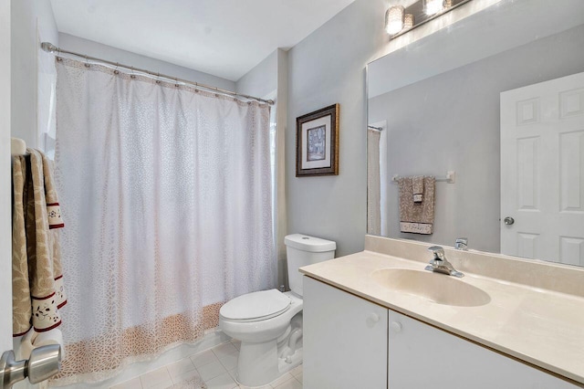 full bathroom with shower / bath combo with shower curtain, tile patterned flooring, vanity, and toilet