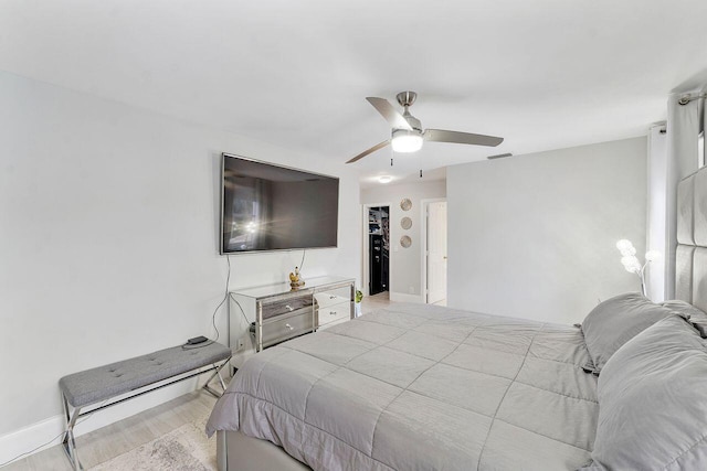 bedroom with ceiling fan and light wood-type flooring