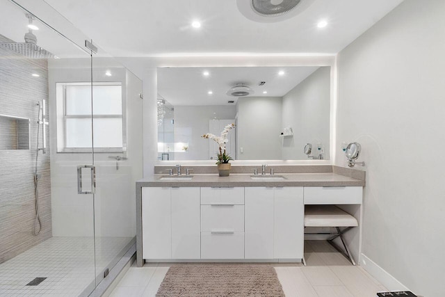 bathroom featuring tile patterned flooring, vanity, and a shower with shower door