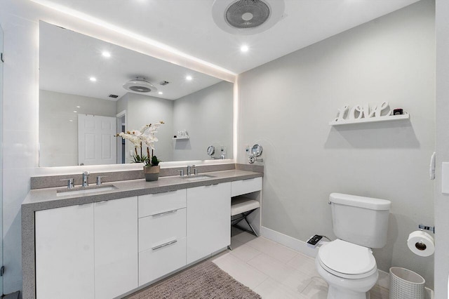 bathroom featuring tile patterned floors, vanity, and toilet