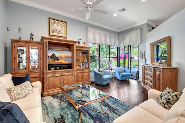 living room featuring dark hardwood / wood-style floors, ceiling fan, and crown molding