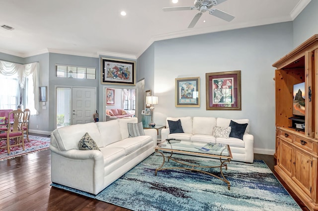 living room with ornamental molding, ceiling fan, and dark wood-type flooring