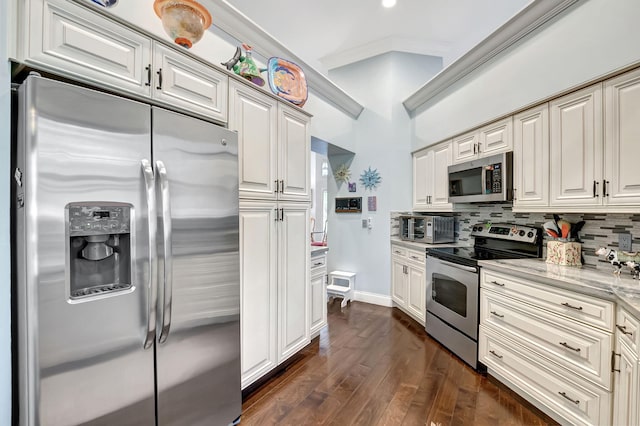 kitchen with light stone counters, dark hardwood / wood-style flooring, backsplash, crown molding, and appliances with stainless steel finishes