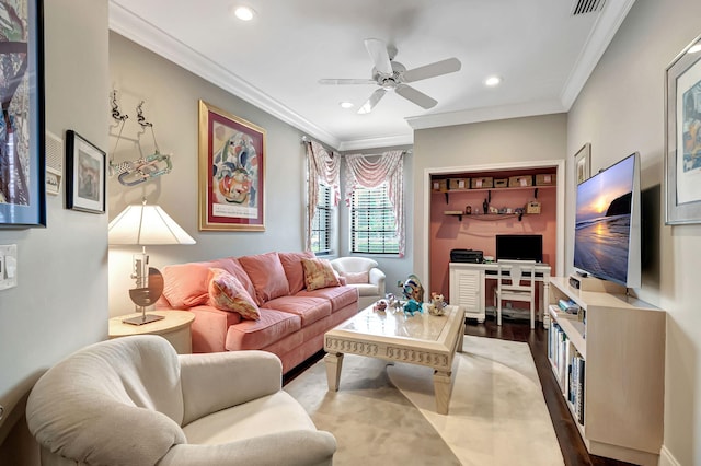 living room with hardwood / wood-style floors, ceiling fan, and crown molding