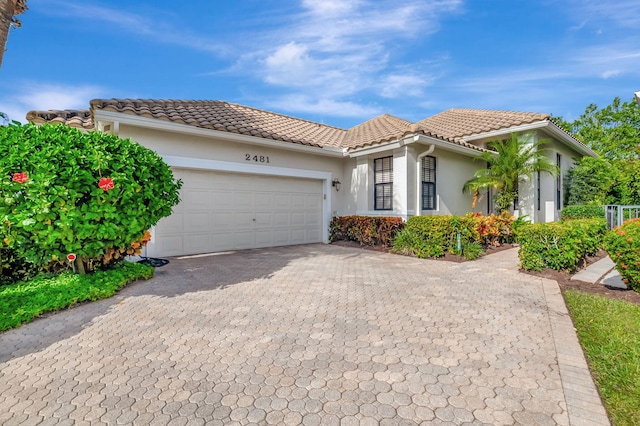 mediterranean / spanish-style home with a garage