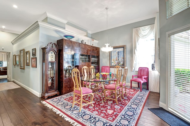 dining space featuring ornamental molding, dark hardwood / wood-style flooring, and a notable chandelier