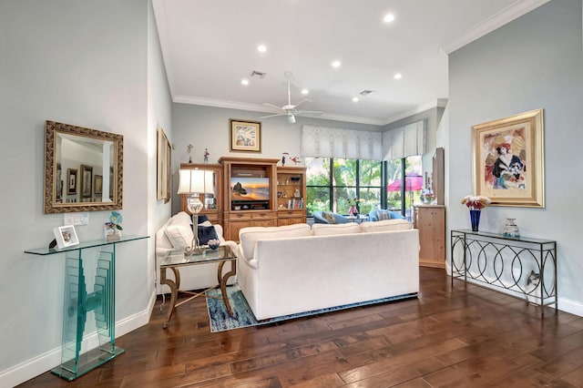 living room with crown molding, ceiling fan, and dark wood-type flooring