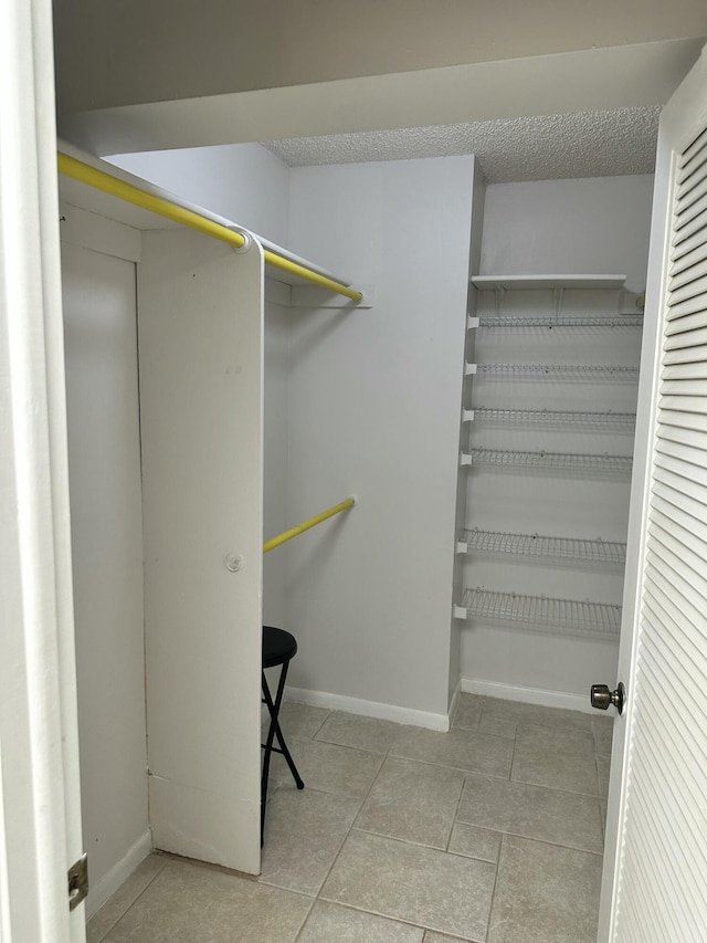 spacious closet featuring light tile patterned floors