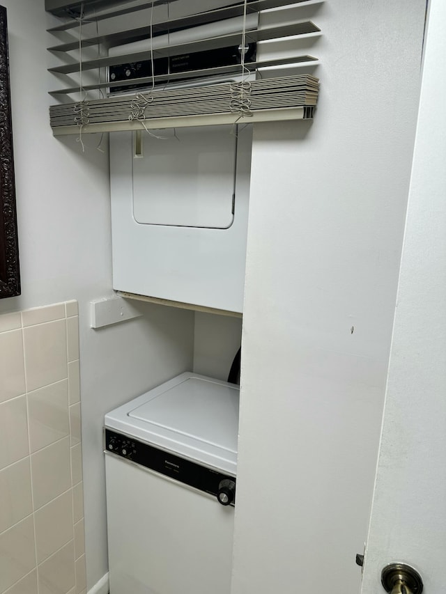 laundry area featuring stacked washer / dryer