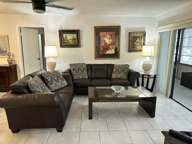 tiled living room with ceiling fan and a textured ceiling