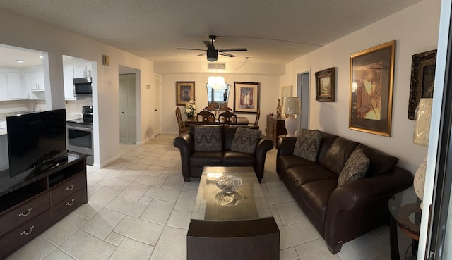 tiled living room with ceiling fan and a textured ceiling