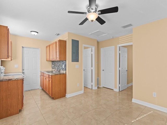 kitchen featuring ceiling fan, sink, tasteful backsplash, electric panel, and light tile patterned floors