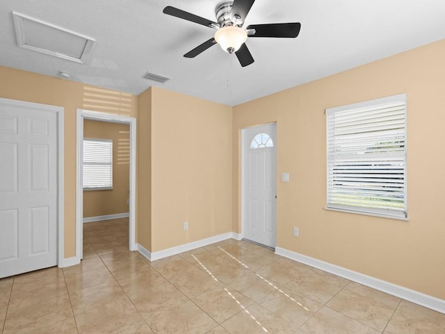 interior space with ceiling fan