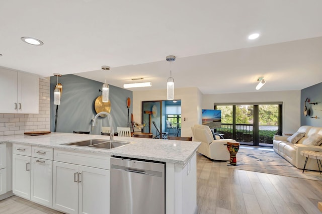 kitchen featuring sink, white cabinets, stainless steel dishwasher, and light hardwood / wood-style flooring