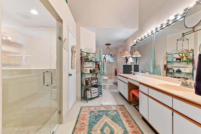 bathroom featuring tile patterned floors, vanity, and an enclosed shower