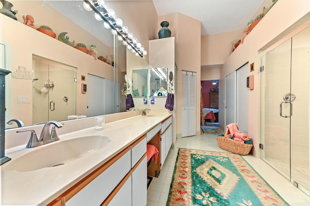 bathroom with tile patterned flooring, vanity, and an enclosed shower