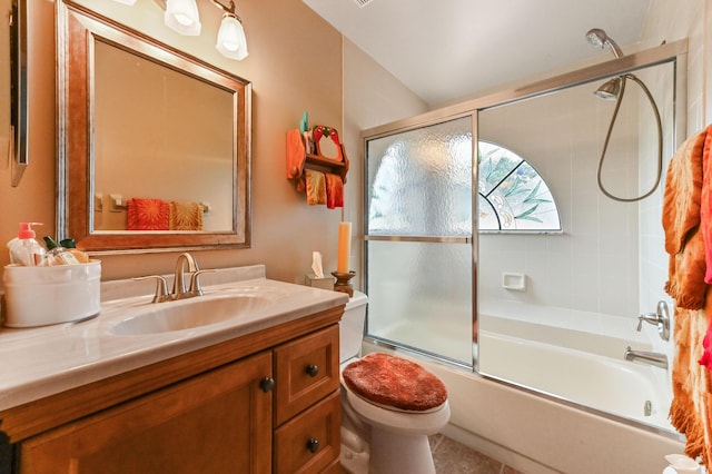 full bathroom with tile patterned floors, vanity, toilet, and bath / shower combo with glass door