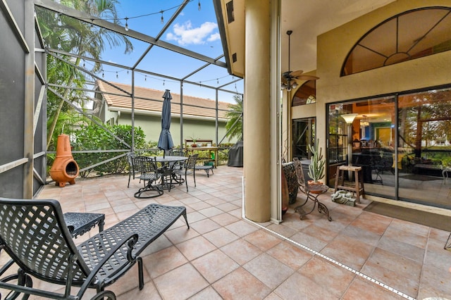 view of patio / terrace featuring glass enclosure